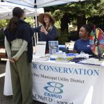 People talking at the EBMUD table